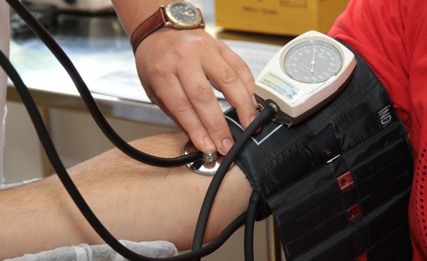 Why High Blood Pressure Is Known As The Silent Killer? Health professional taking blood pressure.